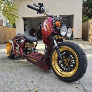 Red Modified Honda Zoomer, this has golden wheels and stickers on the body