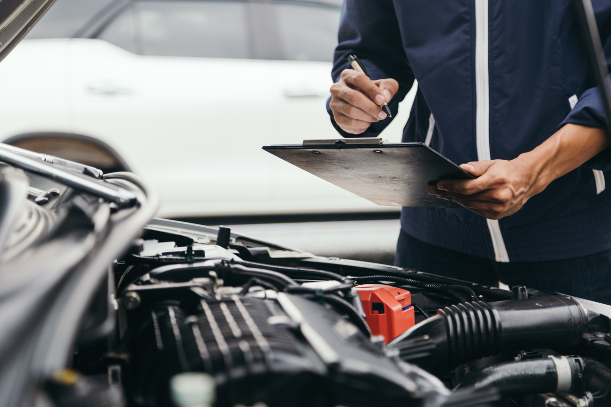 Service my car - mechanic doing engine diagnostics during a car service