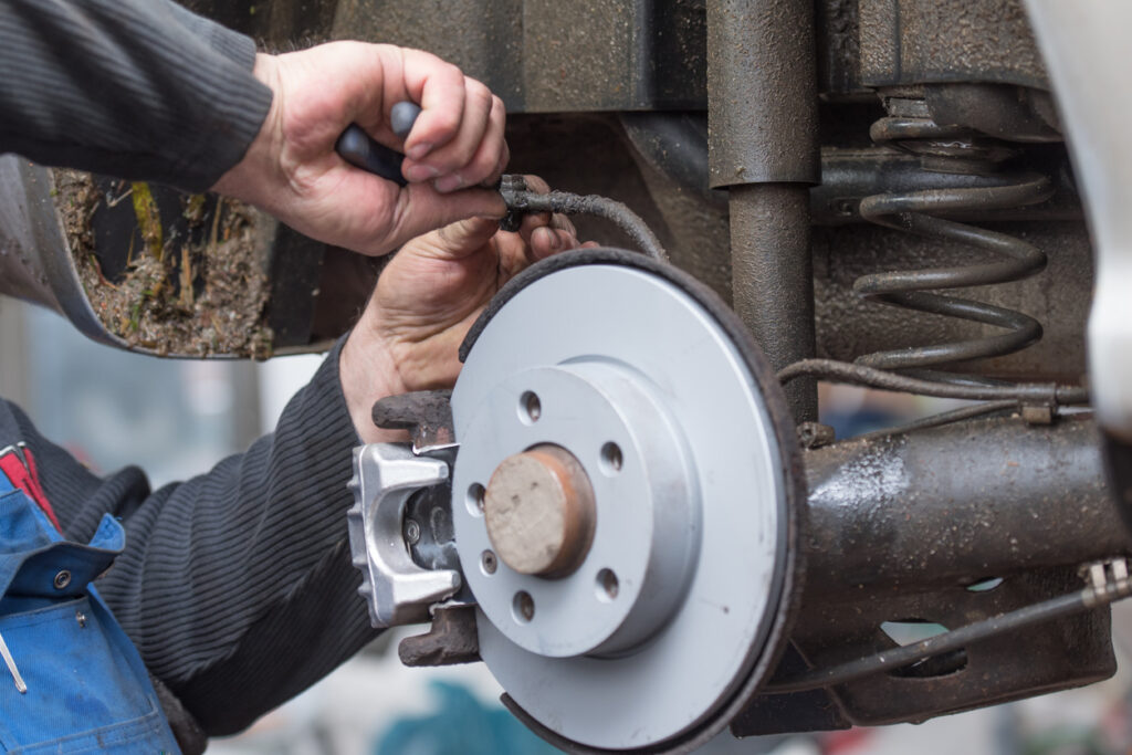 Local mechanic fixing brakes during car brake services
