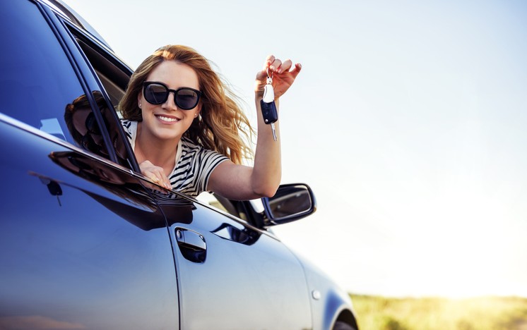 appy woman leaning out of car window. Trade in your car