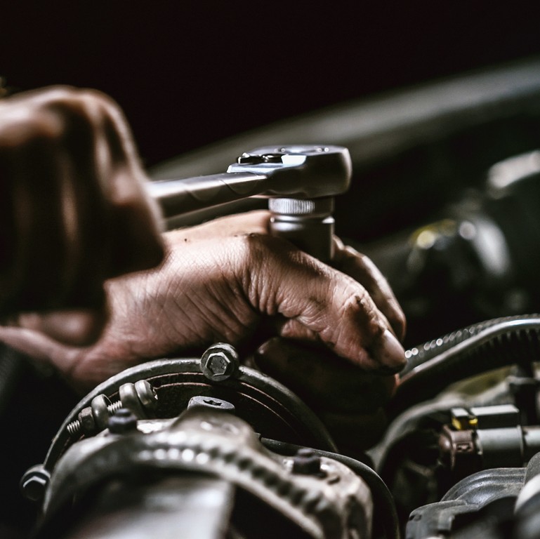 A mechanic using a spanner during a log book services geelong vic 