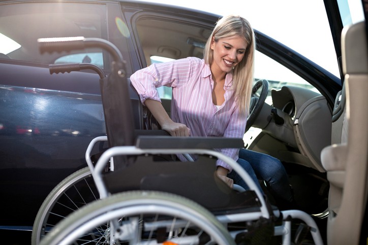 Blonde woman in pink shirt uses a Wheelchair-Accessible Vehicle 