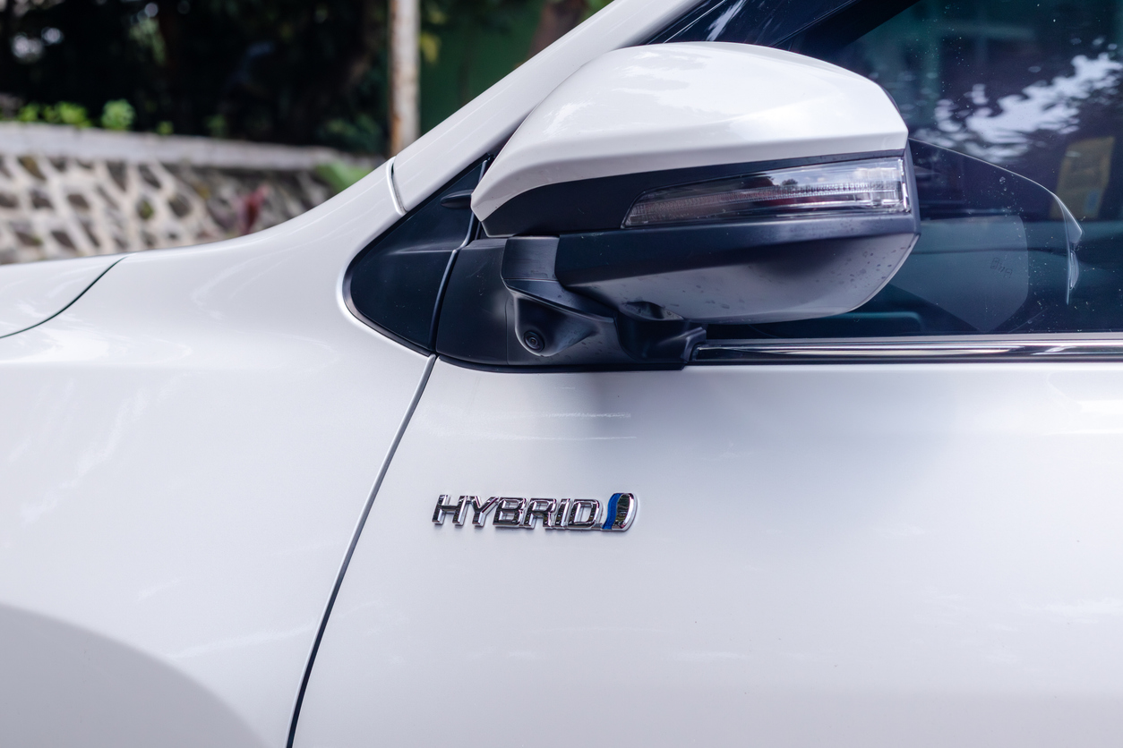 Close up of Hybrid logo on a white car during hybrid car service at Davey Motor Group
